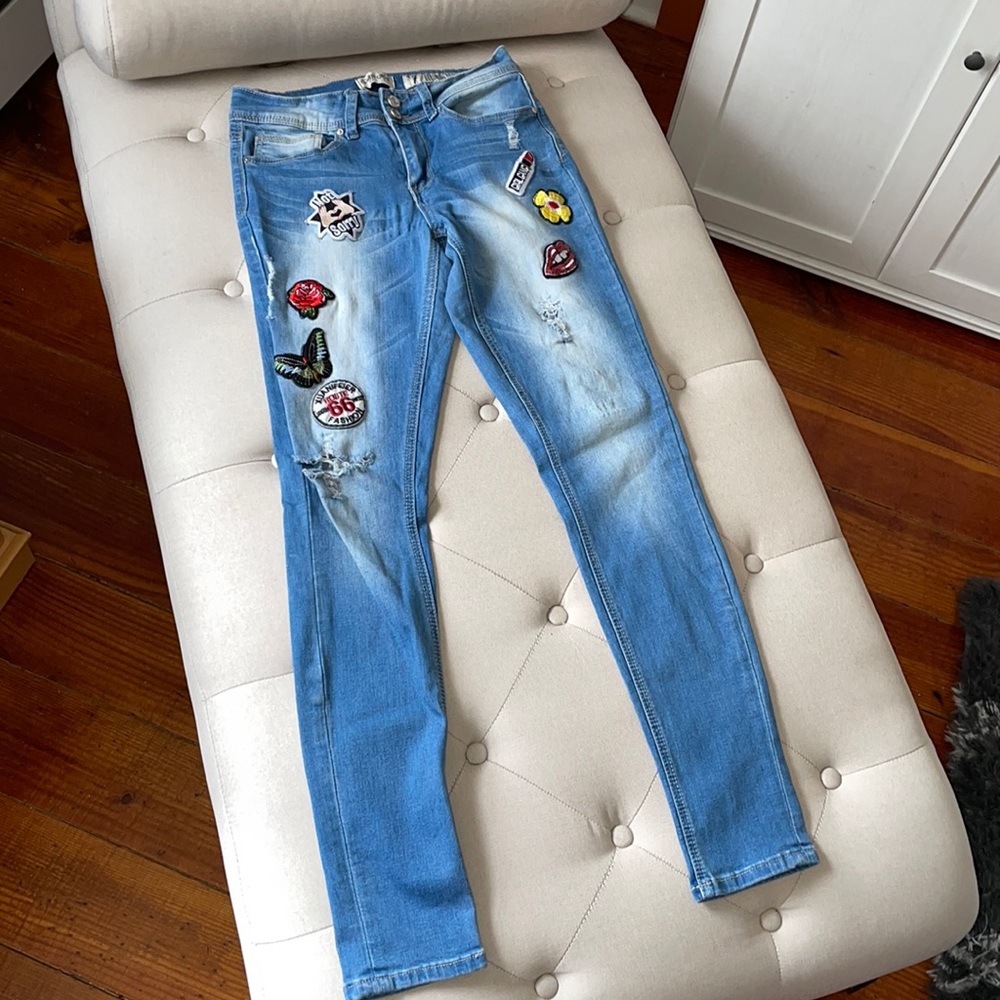 Distressed patched blue jeans